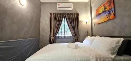 a bedroom with a large white bed with a window at 1-5Pax Bayu Beach SEAFRONT,POOL,STEAMBOAT,BBQ in Port Dickson