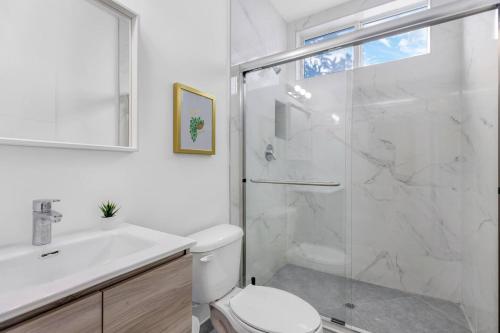 a bathroom with a shower and a toilet and a sink at Up to 16 guests! Modern house near Wynwood in Miami