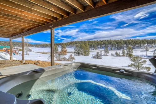 an outdoor hot tub with a view of a snowy mountain at 128 Capitan Circle ("Basecamp") in Pagosa Springs