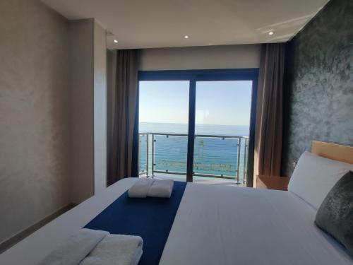 a bedroom with a large bed and a large window at RS Apartments - AL HOCEIMA in Al Hoceïma