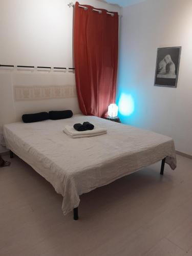 ein Schlafzimmer mit einem Bett mit einem roten Vorhang in der Unterkunft Casa Relax in Sassari