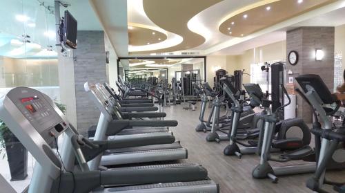 a gym with rows of treadmills and elliptical machines at Casa Vive Grand by Kukun in Mexico City