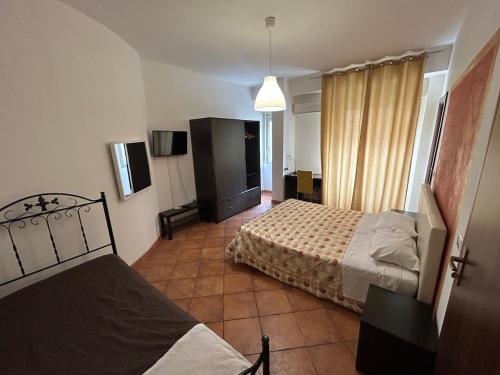 um quarto de hotel com duas camas e uma televisão em Bed and Breakfast Soleil em Caltanissetta