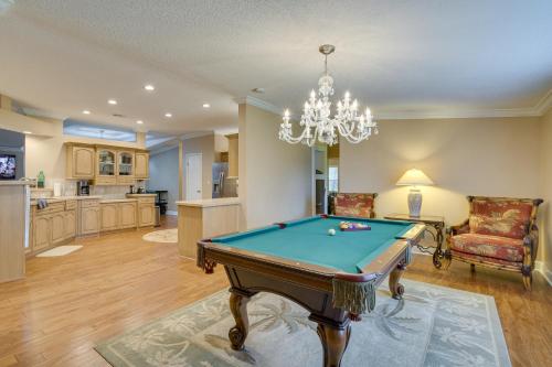 a living room with a pool table and a chandelier at Waterfront Georgetown Retreat on Lake George! in Georgetown