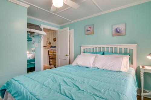 a blue bedroom with a bed with a white headboard at Ocean City Retreat Near Theme Parks, Walk to Beach in Ocean City
