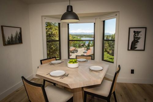 a dining room table with chairs and a large window at 785 Aspenglow Blvd ("Bear's Cliff") in Pagosa Springs
