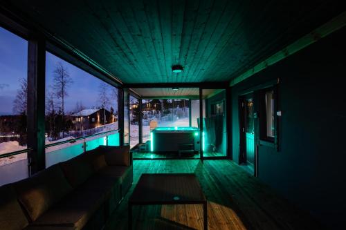 a house with a swimming pool with a tv on the deck at BestVillas Himos Finland in Jämsä