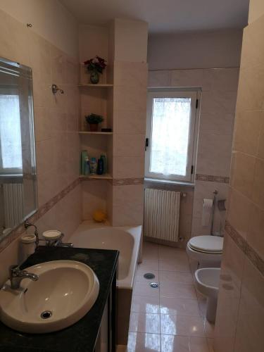 a bathroom with a sink and a tub and a toilet at Casa Vacanze Manzoni Abriola in Abriola