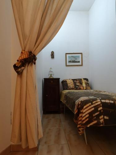 a bedroom with a bed and a curtain at Casa Vacanze Manzoni Abriola in Abriola