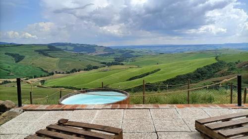 a swimming pool with a view of the hills at Agriturismo Collomici in Celle sul Rigo