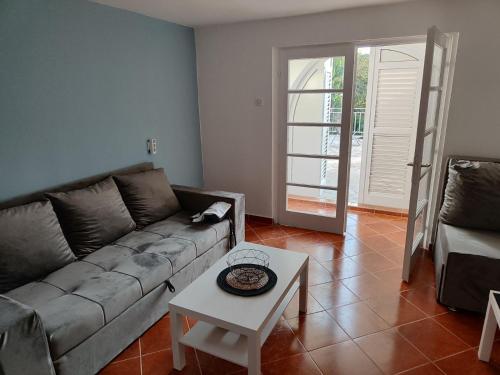 a living room with a couch and a table at Apartmani Nada in Drage