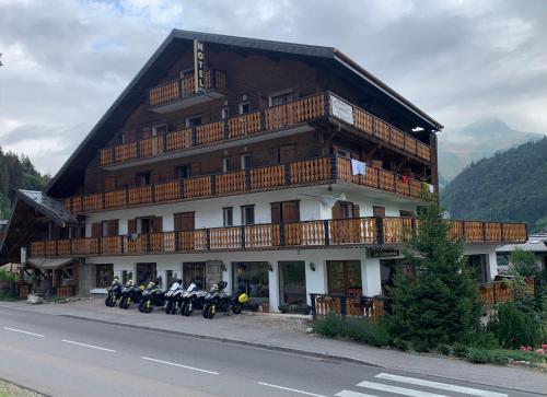 a group of motorcycles parked in front of a building at Hotel Le Concorde in Morzine