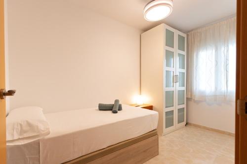 a white bedroom with a bed and a window at Charming 3 Bedroom Apartment at Triana Center By Oui Seville in Seville