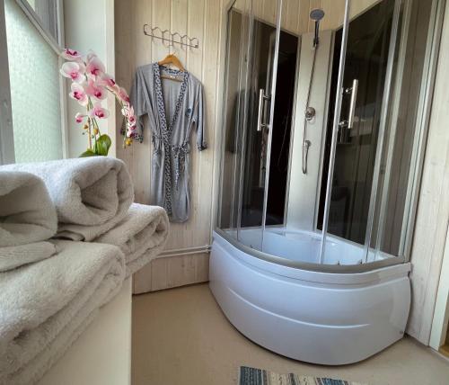 ein Badezimmer mit einer Dusche, einer Badewanne und Handtüchern in der Unterkunft Paide B&B in Paide
