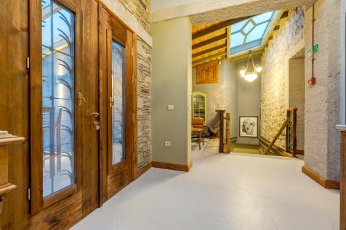 an open hallway with wooden doors and windows at Sakin Ev in Alacati