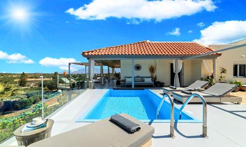 a villa with a swimming pool and a house at Olive Green Villa Heated Pool in Agios Nikolaos