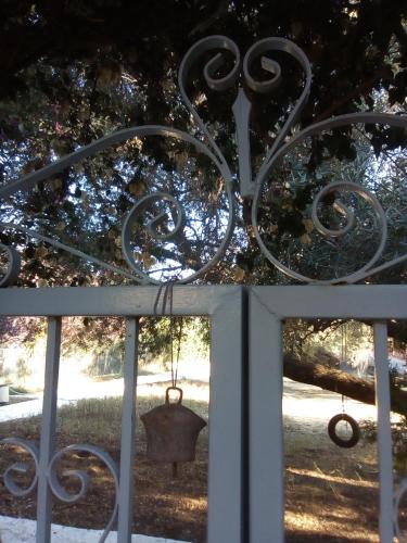 a metal gate with a bell hanging on it at Katelios Farm House Loft in Katelios