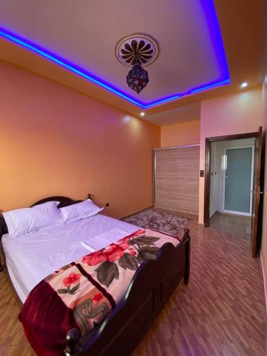 a bedroom with a large bed with a purple ceiling at HOUSE OF AIT BIHI TAGHAZOUT in Agadir