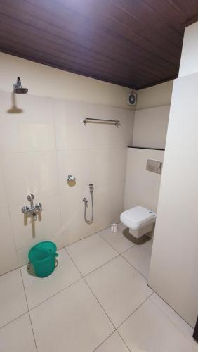 a bathroom with a toilet and a sink at Muziris Manor Residency in Cochin