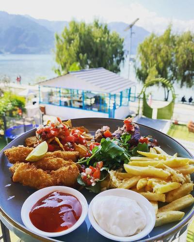 a plate of food with fried fish and french fries at Majestic Lake Front Hotel & Suites in Pokhara