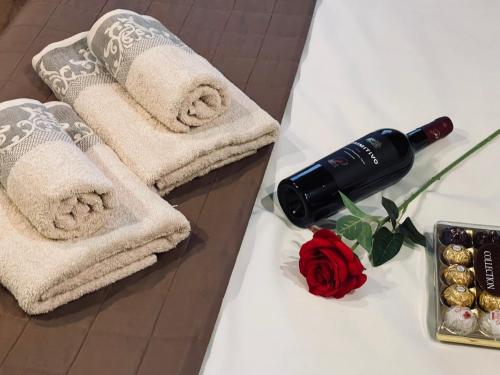 a couple of towels on a table with a bottle of wine at Nirvana in Rivne