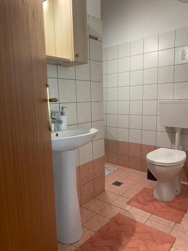 a bathroom with a sink and a toilet at Maria's Central Apartment in Igoumenitsa