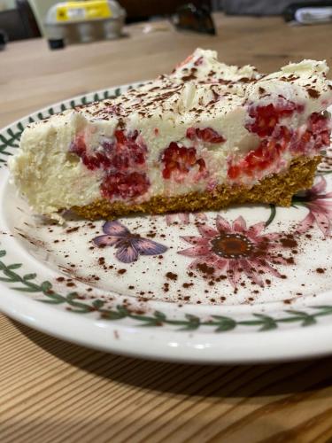 a piece of cake on a plate on a table at Dennis in Goodwick