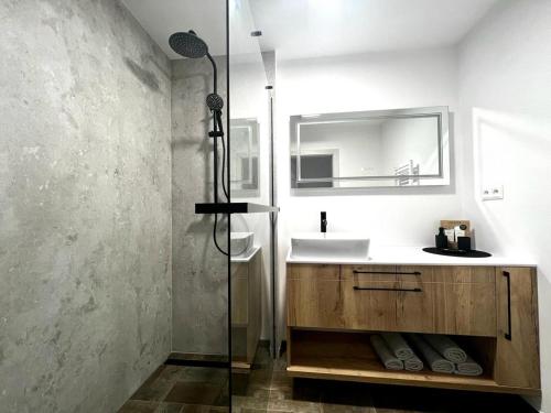 a bathroom with a sink and a shower at Urban ZION apartment in Liptovský Mikuláš