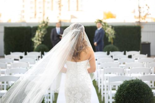 a bride walking down the aisle with her veil at Sheraton Fallsview Hotel in Niagara Falls