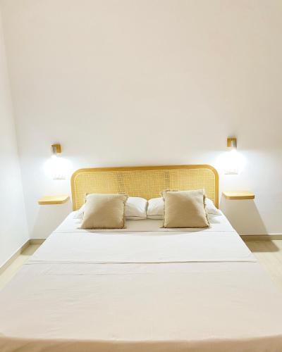 a large white bed with two pillows on it at CASA SACURI in Rudalza