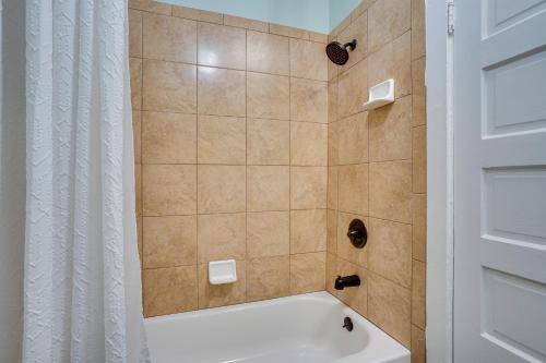 a shower with a white curtain and a tub at Long Beach Vacation Rental Near Downtown and Beaches in Long Beach