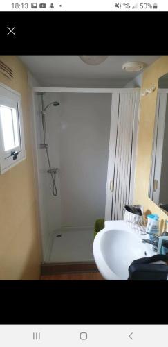 a bathroom with a white sink and a shower at Mobile home dans camping frejus in Fréjus