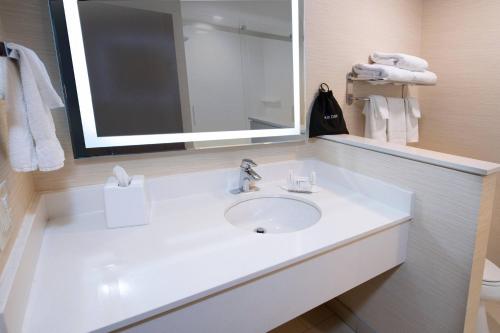 a bathroom with a white sink and a mirror at Fairfield Inn & Suites by Marriott Edmonton North in Edmonton