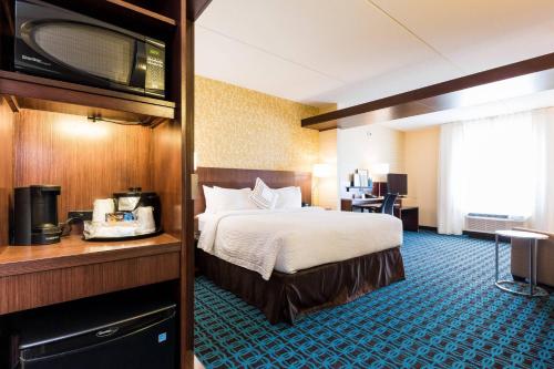 a hotel room with a bed and a television at Fairfield Inn & Suites by Marriott Edmonton North in Edmonton
