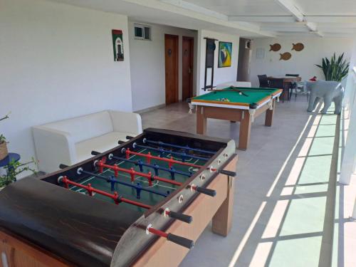 a room with a pool table and ping pong balls at Hotel Vivenda dos Corais in Porto De Galinhas