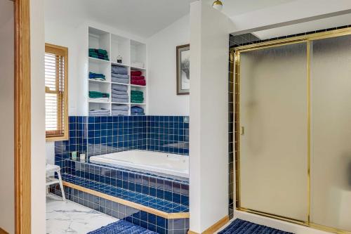 een blauwe betegelde badkamer met een bad en een douche bij Remote WY Ranch with 170 Acres and Views Galore! in Glenrock