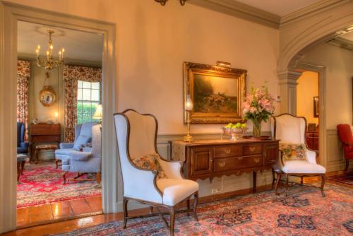 a living room with two chairs and a table at Francis Malbone House in Newport