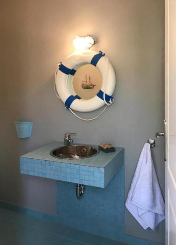 a bathroom with a sink and a mirror on the wall at new serenity villa aegina in Aegina Town