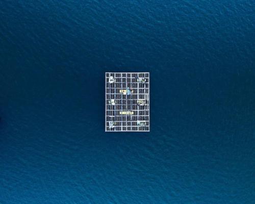 a tall building in the middle of the water at Apto Solpor, terraza y parking in Cambados