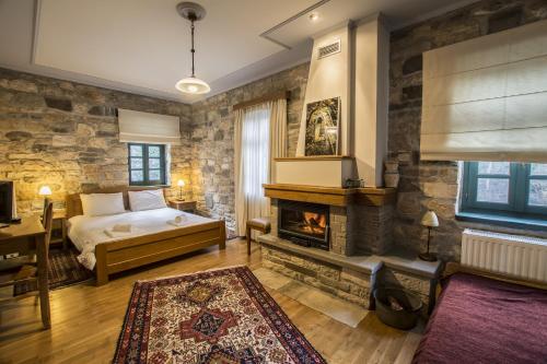 a bedroom with a bed and a fireplace at Gaia Guesthouse in Dilofo