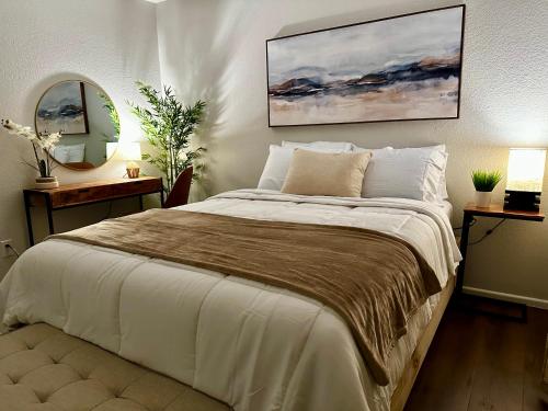 a bedroom with a large bed and a mirror at Modernized Stay in Eagle Pass