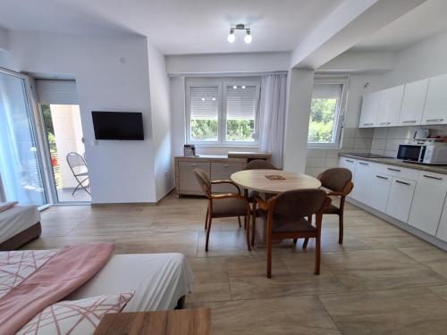 a kitchen and living room with a table and chairs at Apartments Lakeside Elesec in Ohrid
