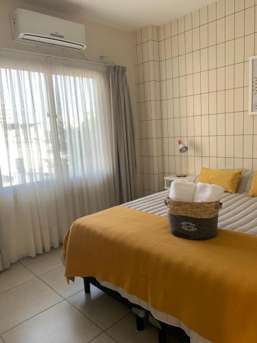 ein Schlafzimmer mit einem Bett und einem Korb darauf in der Unterkunft Amaru - Departamento céntrico con cochera in Corrientes