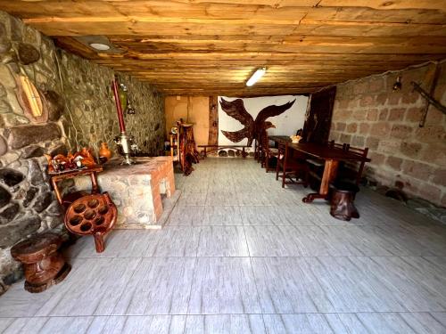a room with a fireplace and a table and chairs at Yerivar in Semyonovka