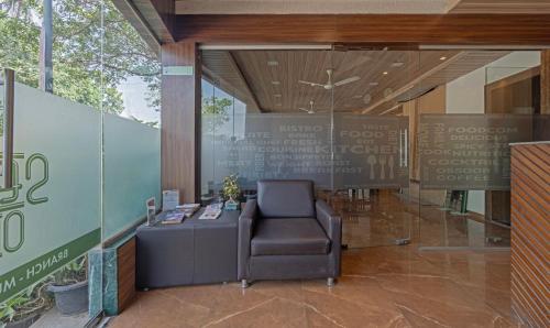 a chair sitting in the lobby of a building at Treebo Seven Olives in Mumbai