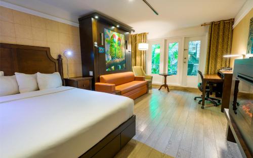 a hotel room with a bed and a desk at L'Hôtel Québec par JARO in Quebec City