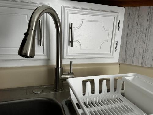 a kitchen sink with a faucet and a dish rack at Modernized Stay in Eagle Pass
