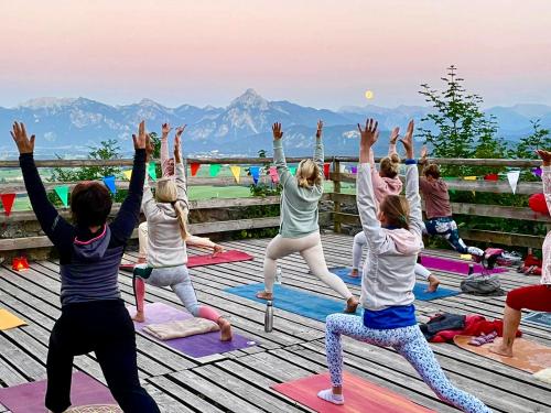 a group of people doing yoga on a deck at Landhotel Gockelwirt in Eisenberg