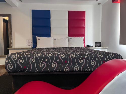 a bedroom with a large bed with colorful walls at MOTEL SENA in Ensenada