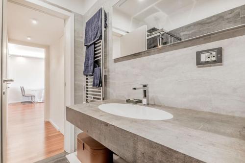 a bathroom with a white sink in a room at Luxury apartment front of Cavalieri Hilton Hotel in Rome